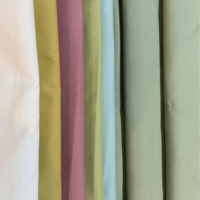 Sibbi Gold men's suiting fabric bolts in pastel white, olive, mauve, sage, sky blue and pistachio shades